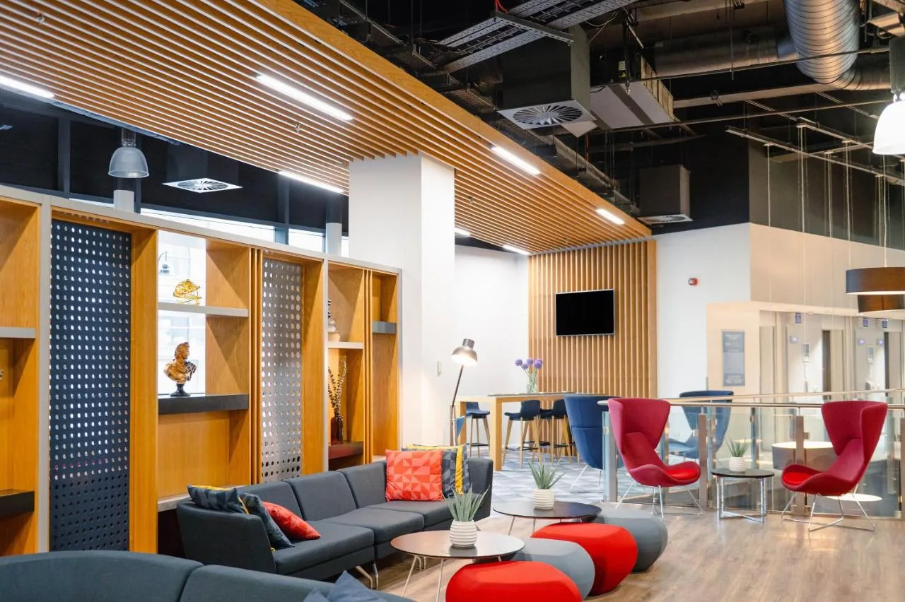 a lobby with a couch and chairs and a table at Holiday Inn Express - Birmingham - City Centre by IHG in Birmingham