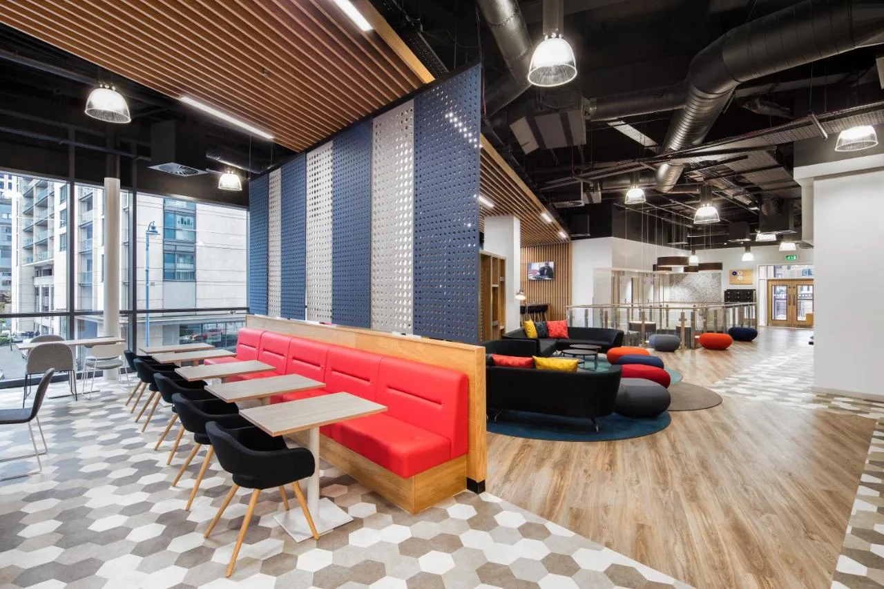 a lobby with red chairs and tables at Holiday Inn Express - Birmingham - City Centre by IHG